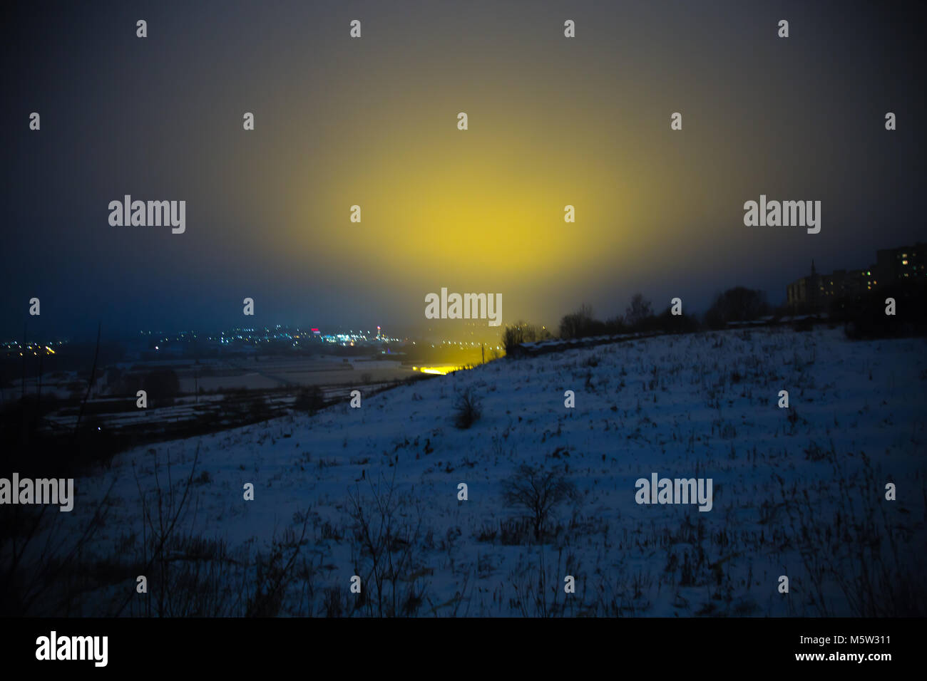 Winter hills blue sky yellow light background Stock Photo