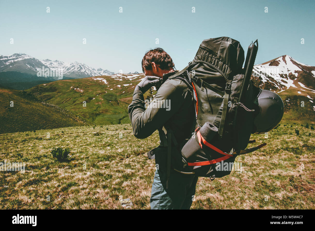 Travel Man with big backpack  mountaineering Lifestyle survival concept adventure outdoor active summer vacations climbing sport gear wild nature moun Stock Photo