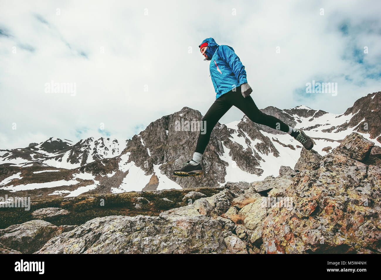 Active Man running in mountains Travel adventure healthy lifestyle concept vacations athletic