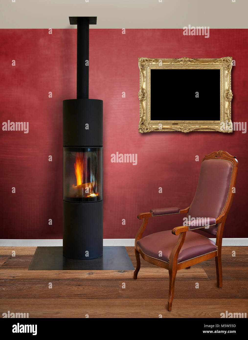 Modern interior with modern wood burner against textured red wall Stock Photo