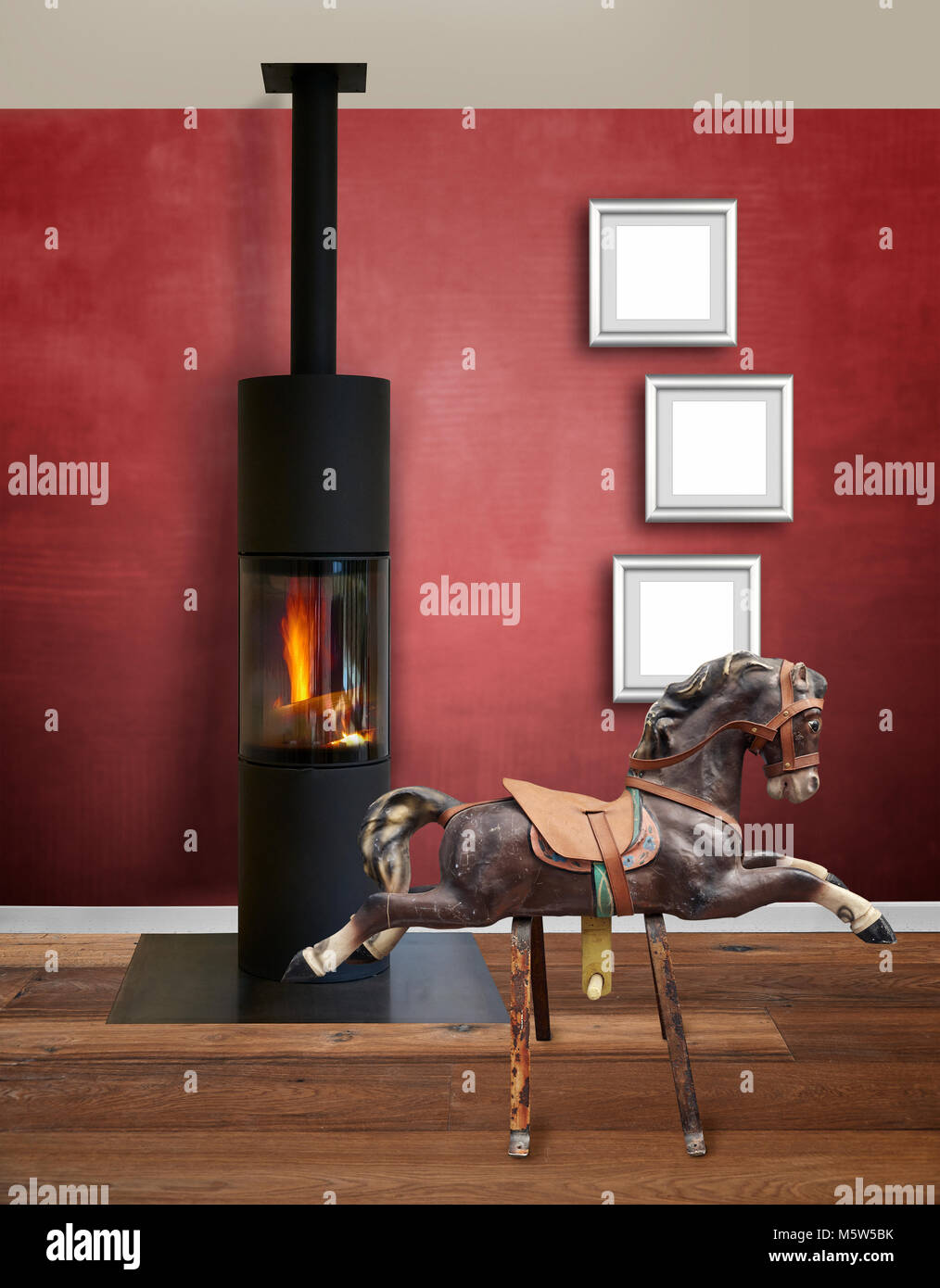 Modern interior with modern wood burner against textured red wall Stock Photo