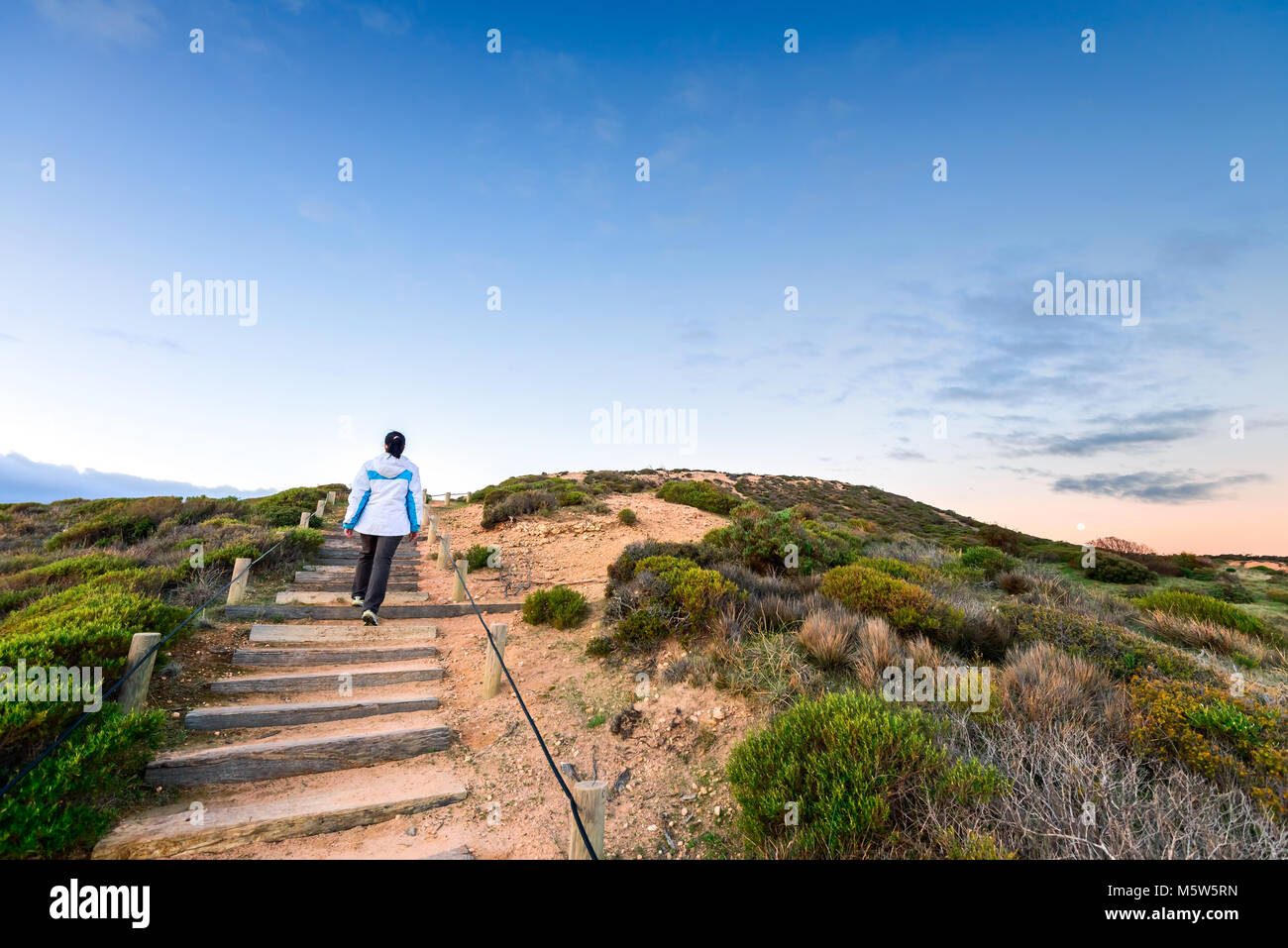 Woman walking up hill hi-res stock photography and images - Alamy