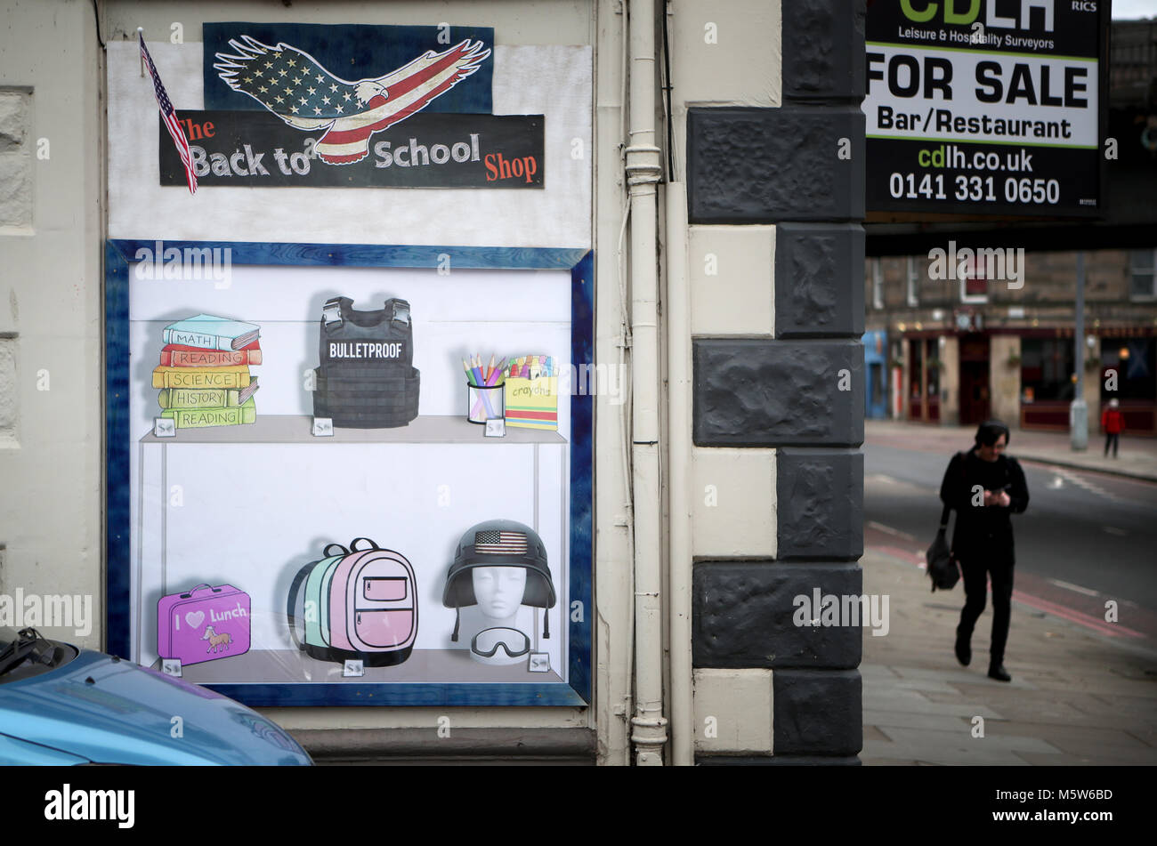 A fake shop window created by Street artist 'The Pink Bear' in Gorgie, Edinburgh, in response to the recent school shootings in Florida and the continuation of the NRA's stronghold in the United States. Stock Photo