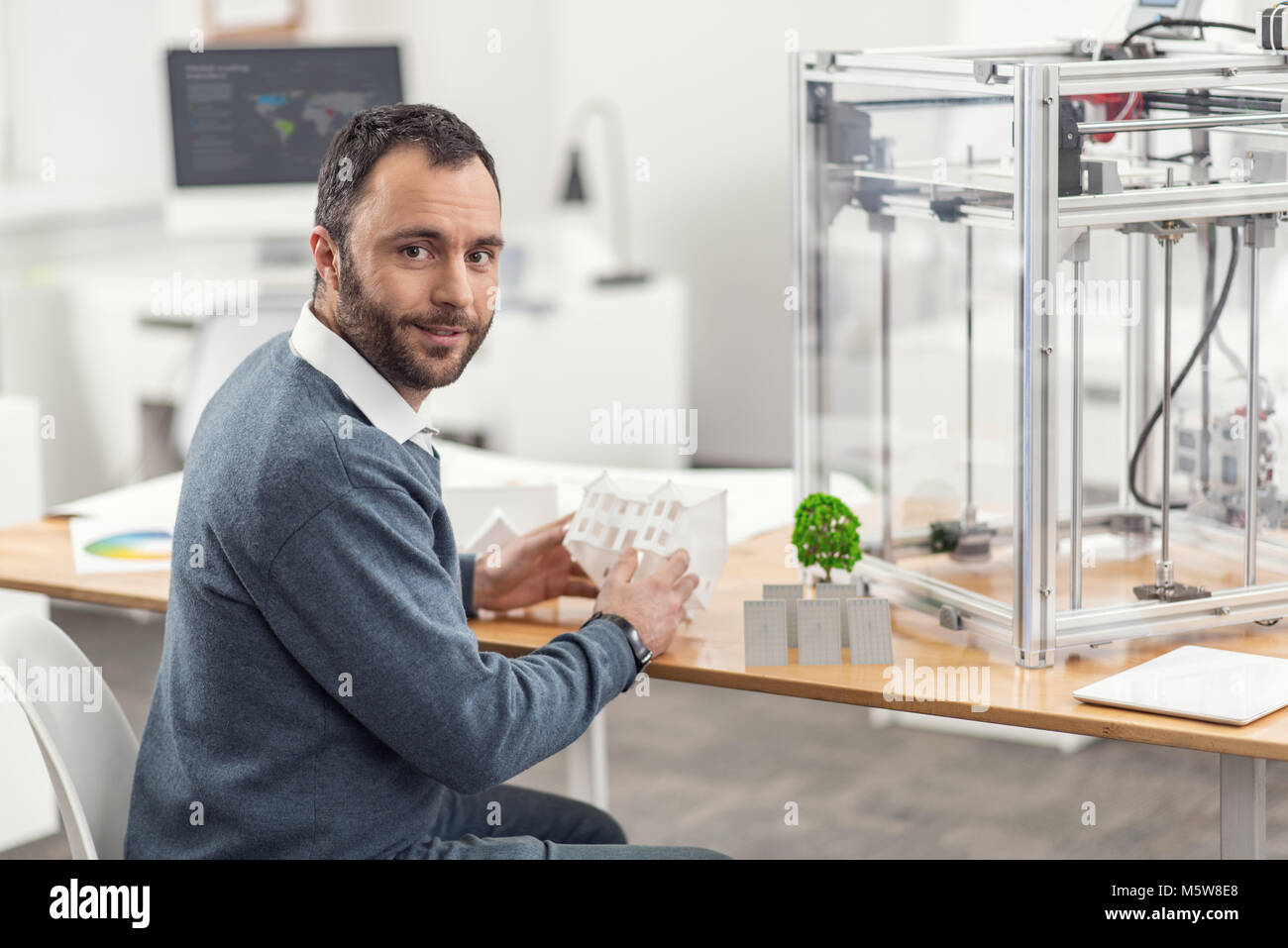 Cheerful engineer posing while working on eco-city project Stock Photo ...