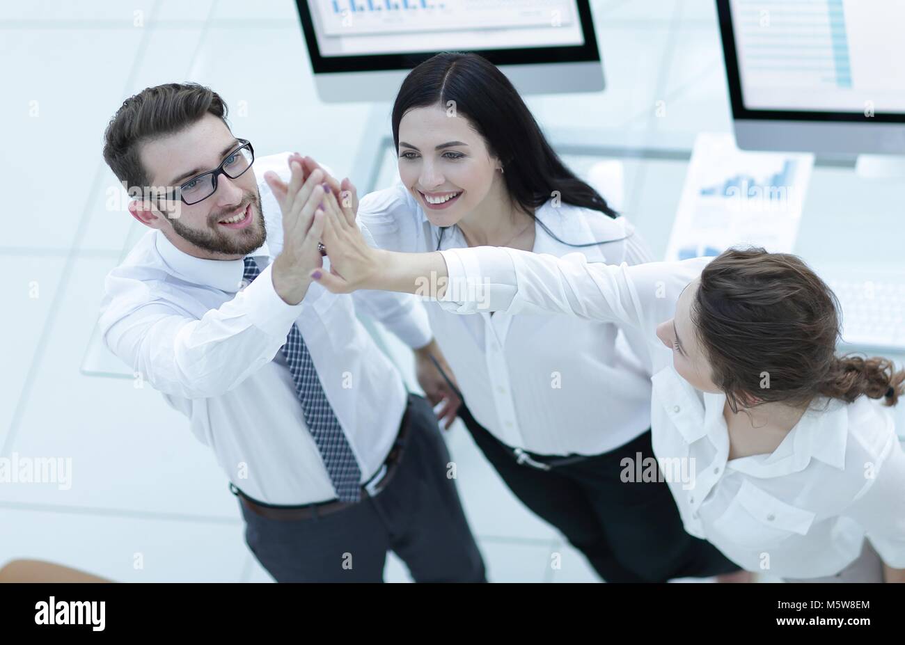 successful business team giving each other a high five Stock Photo - Alamy