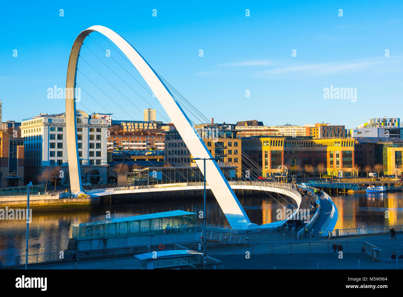 Modern bridge UK, view at sunset of the Millennium Bridge and the Quayside area in the centre of Newcastle upon Tyne, Tyne And Wear, England, UK Stock Photo