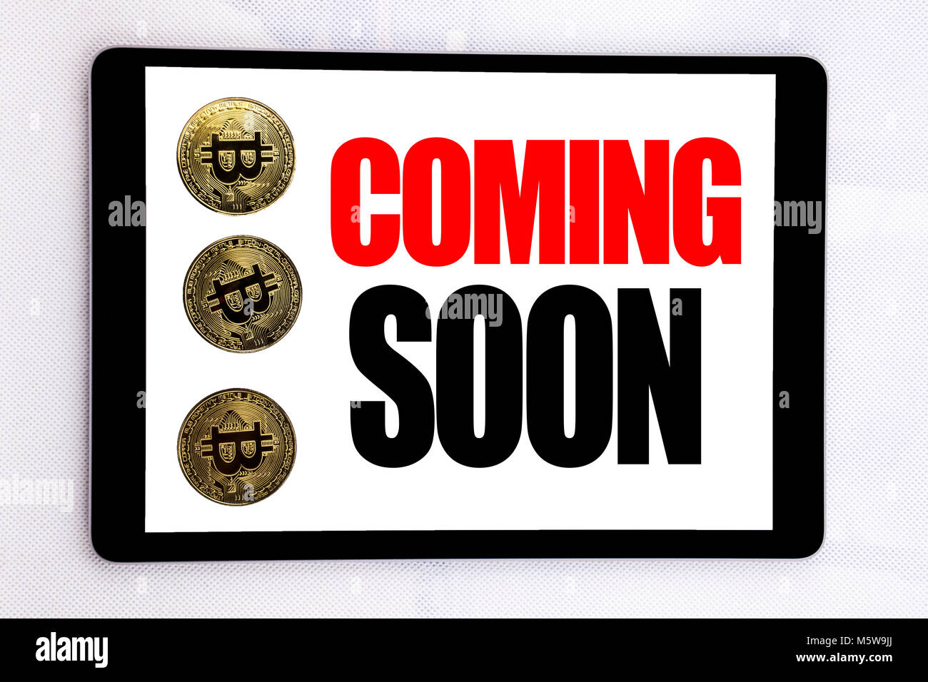 Writing text showing Coming Soon. Business concept for Under Construction  written on tablet screen on white background with cryptocurrency bitcoin  nex Stock Photo - Alamy