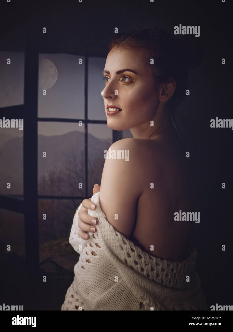 Quiet night. Art female portrait with red head beauty woman, open window and full moon Stock Photo