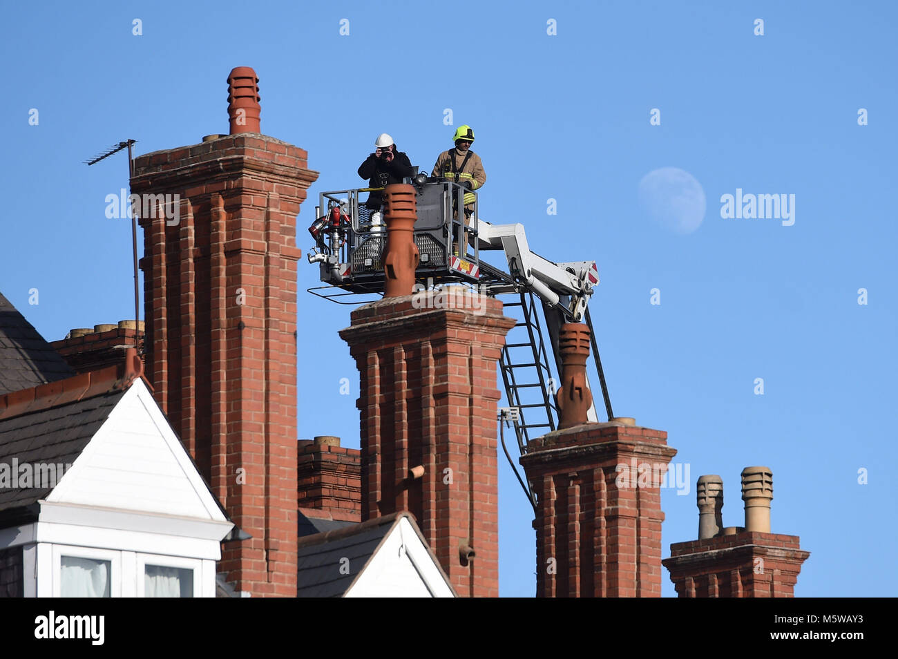 Emergency personnel continue to work at the scene on Hinckley Road in Leicester, where four people were killed, after a suspected explosion and subsequent fire destroyed a shop. Stock Photo