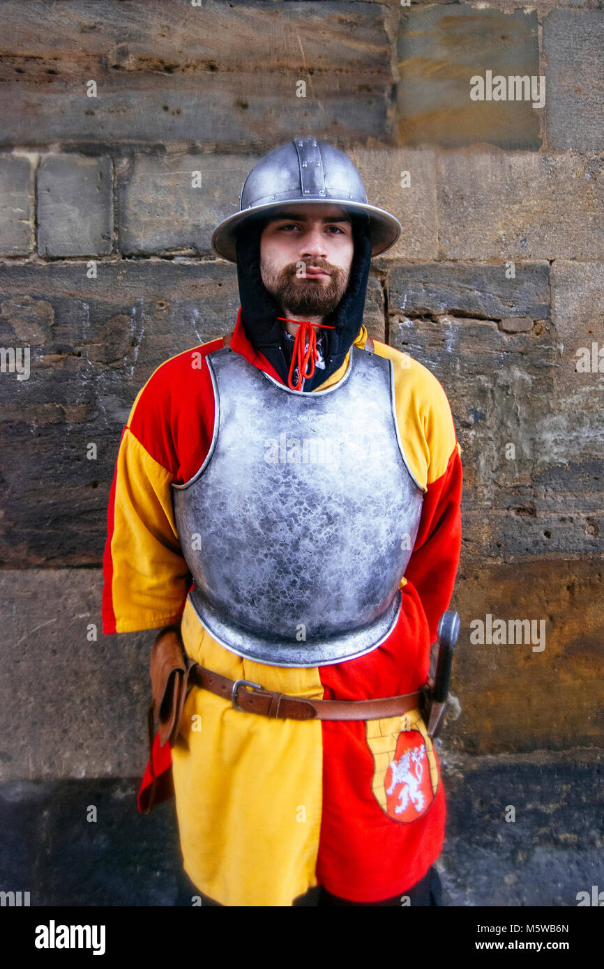 A guard, dressed as a medieval knight (red and yellow colour uniform represents the flag of Prague) at the Powder Tower in Prague, Czech Republic. Stock Photo