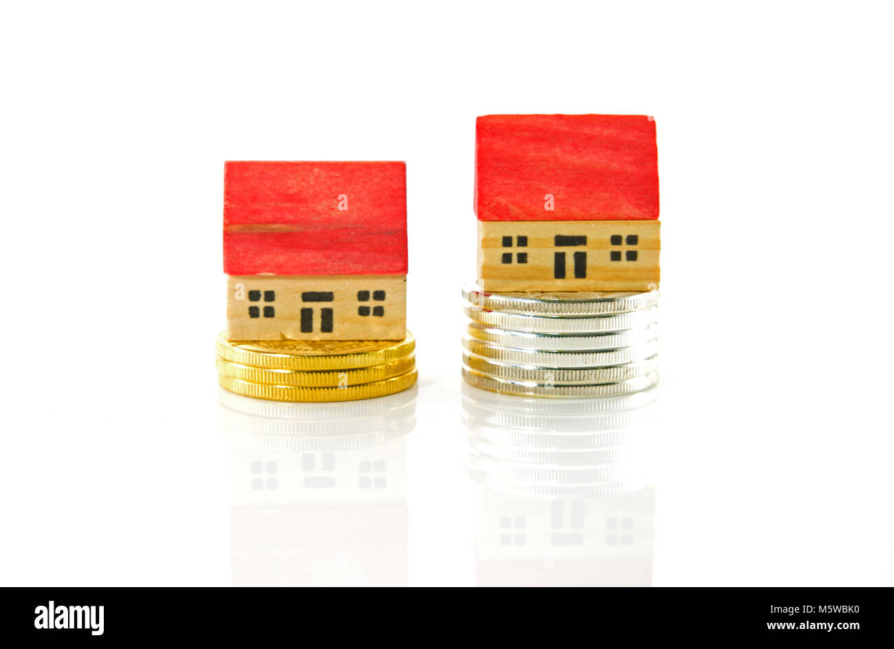 houses on  the market for sale with bitocins or other gold and silver coins Stock Photo