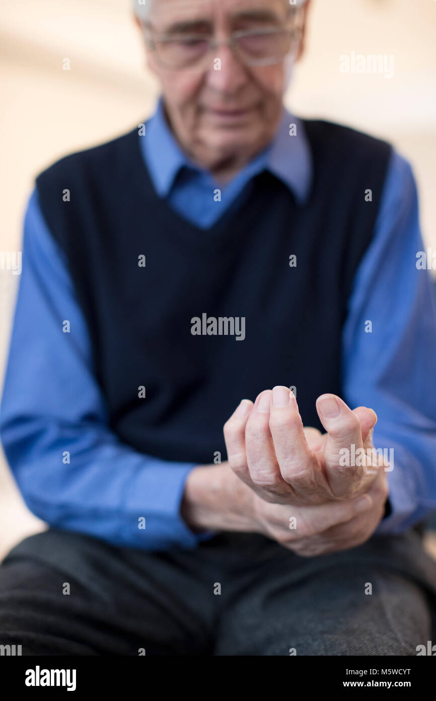 Senior Man At Home Suffering With Arthritis Stock Photo