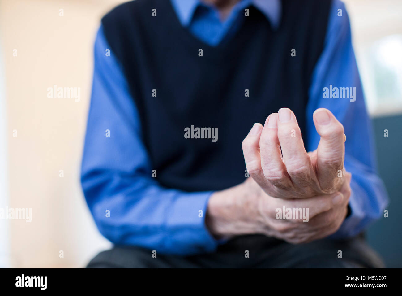 Close Up Of Senior Man At Home Suffering With Arthritis Stock Photo