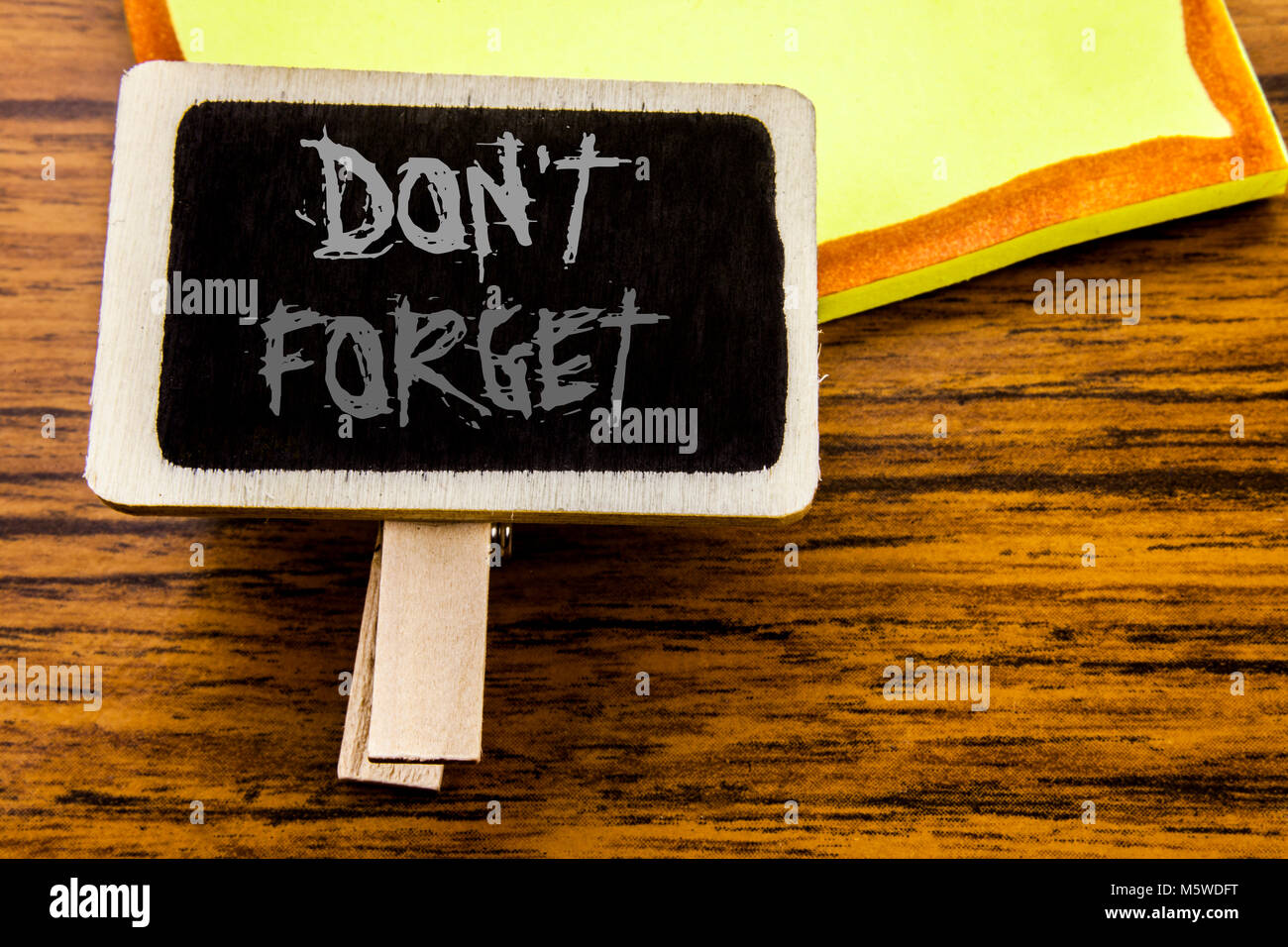 Handwritten text showing Do Not Forget. Business concept for Don t memory Remider written on announcement board on wooden wood background. Stock Photo