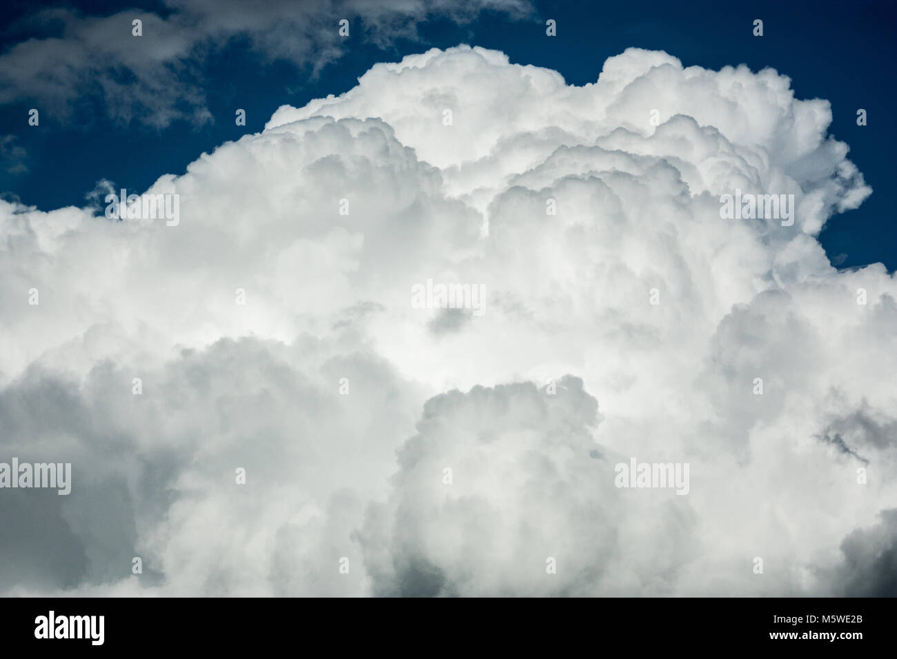 Stratocumulus fluffy cloud formation with blue sky on the top Stock Photo