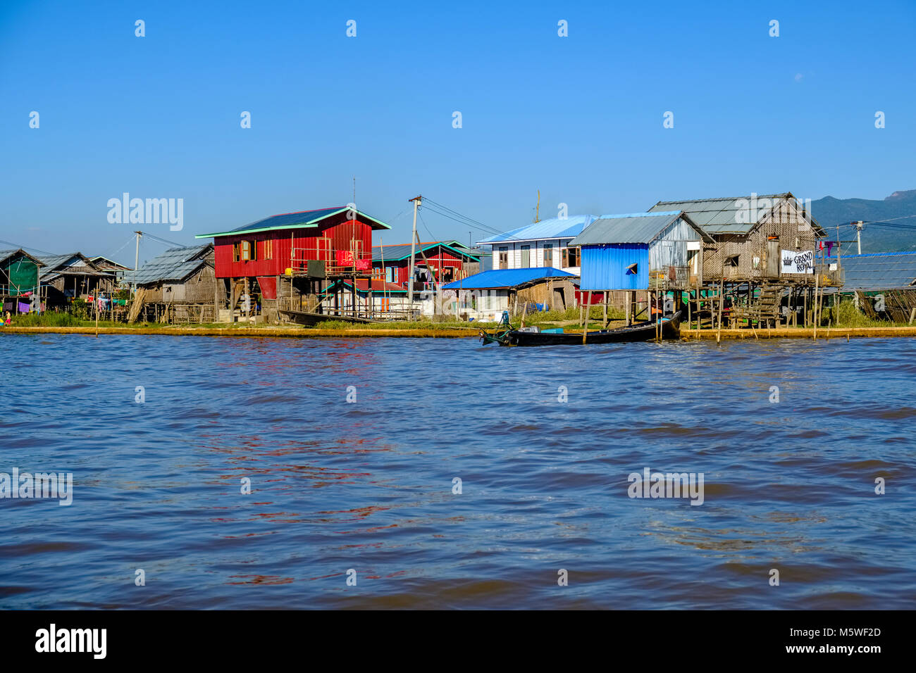 Houses of the local fishermen are situated along the main channel Stock Photo