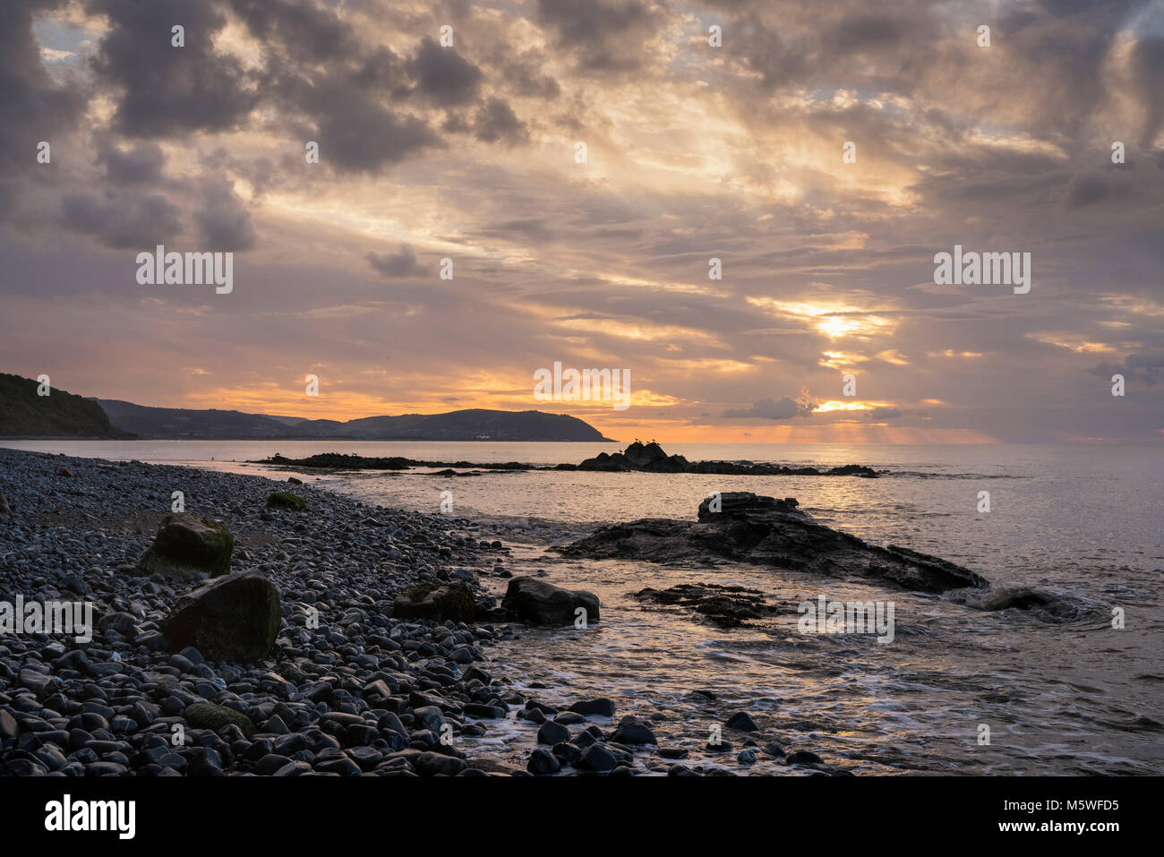 Sunset on the Somerset coastline near Watchet looking across Blue Anchor Bay towards Minehead Stock Photo