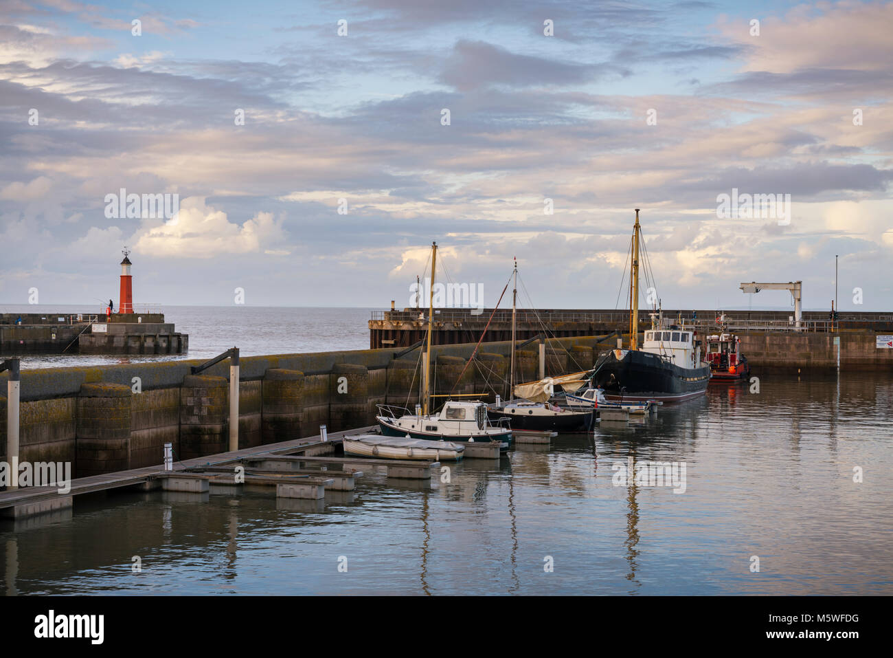 The harbour with lighthouse at Watchet a seaside town in the English county of Somerset between Minehead and Bridgewater in the Exmoor national park. Stock Photo