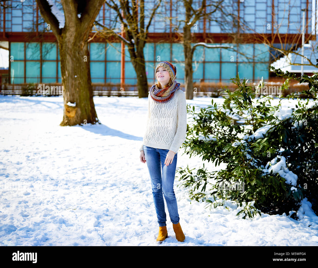 Beautiful woman in snowy city park Stock Photo
