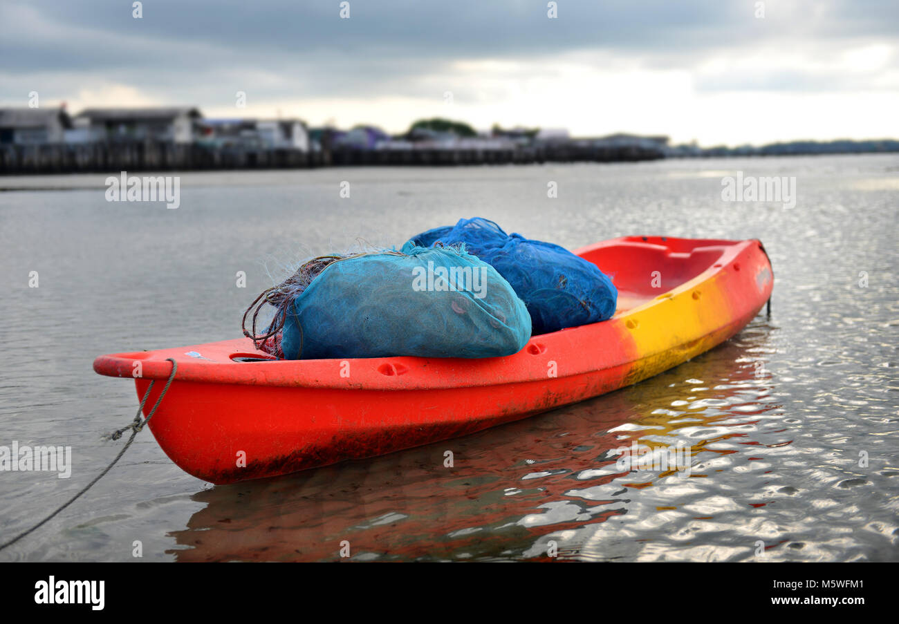 Fisherman kayak rest time Thai sea season rainy Stock Photo