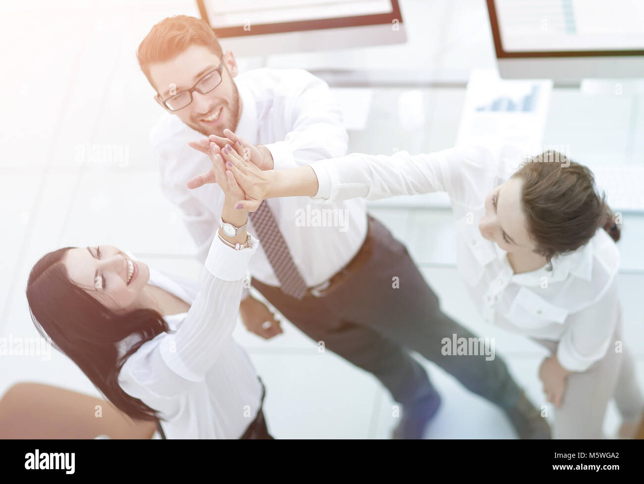 successful business team giving each other a high five Stock Photo - Alamy