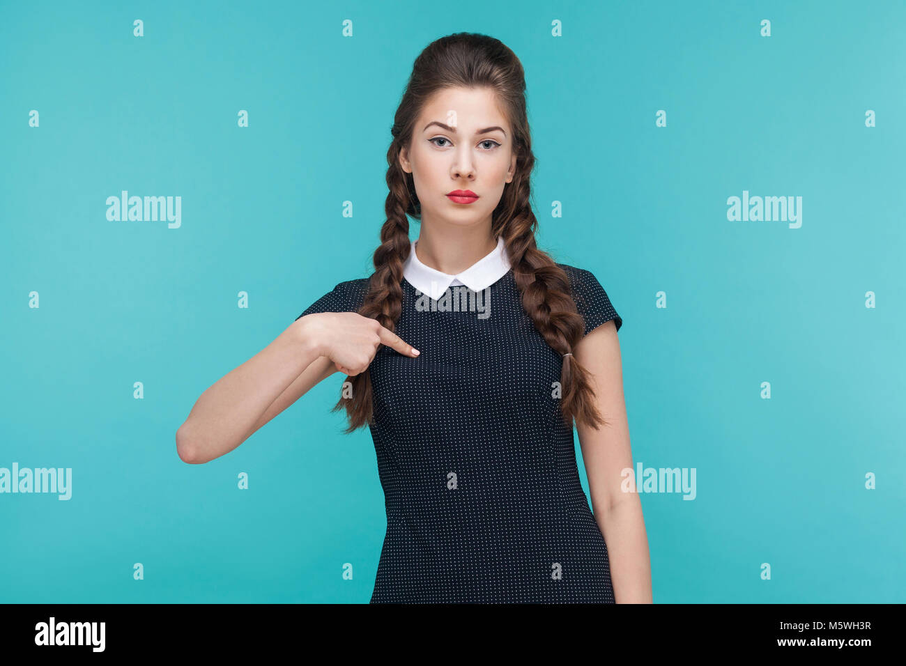 Seriously arrogant businesswoman pointing finger himself, looking at camera. Studio shots Stock Photo