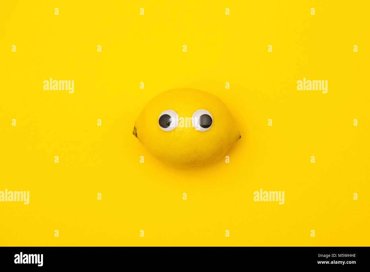 Yellow lemon face with comedy googly eyes Stock Photo