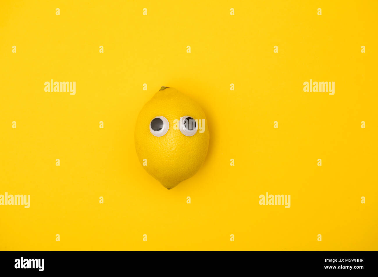 Yellow lemon face with comedy googly eyes Stock Photo