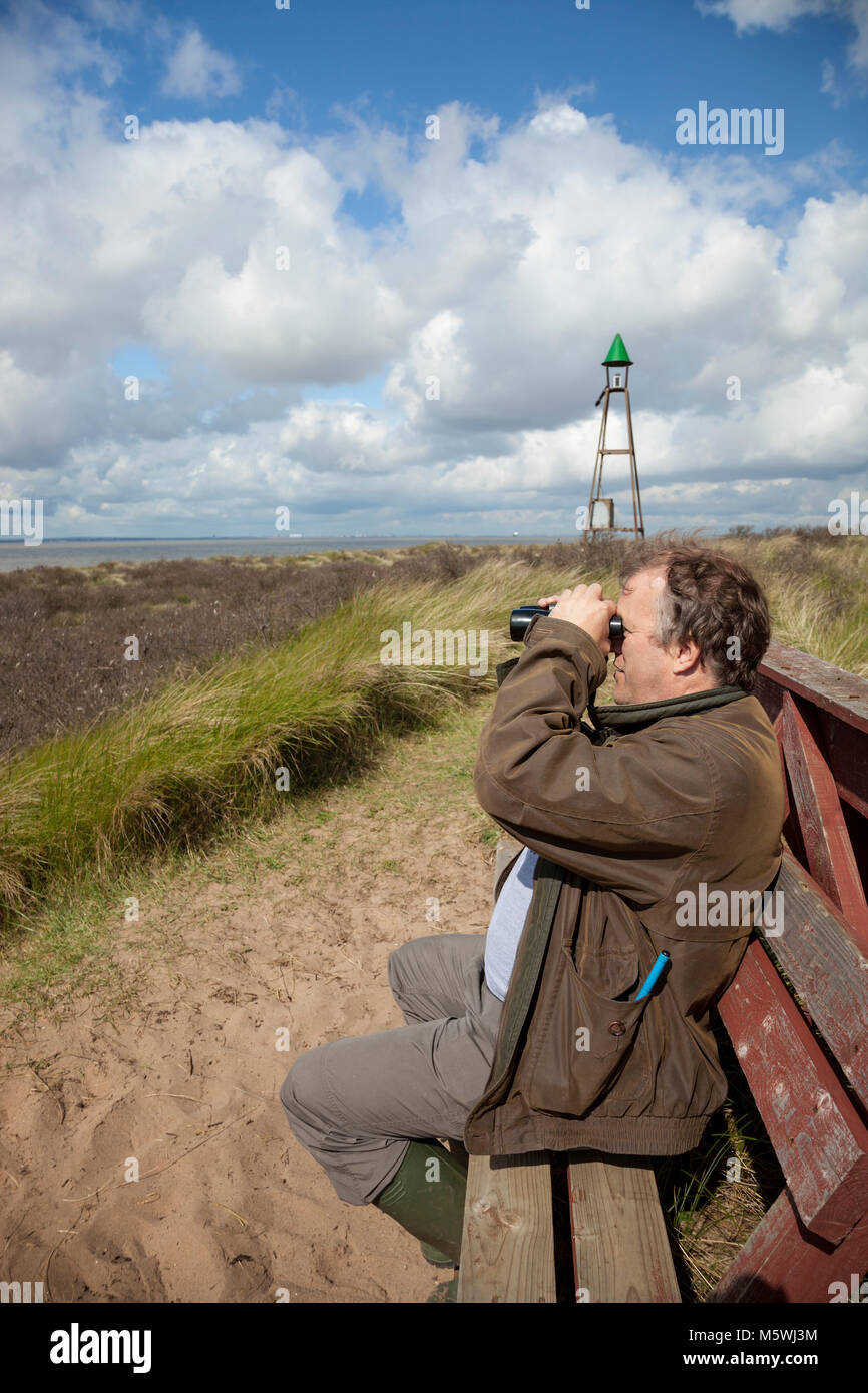 Birder at Spurn carrying out visible migration monitoring Stock Photo