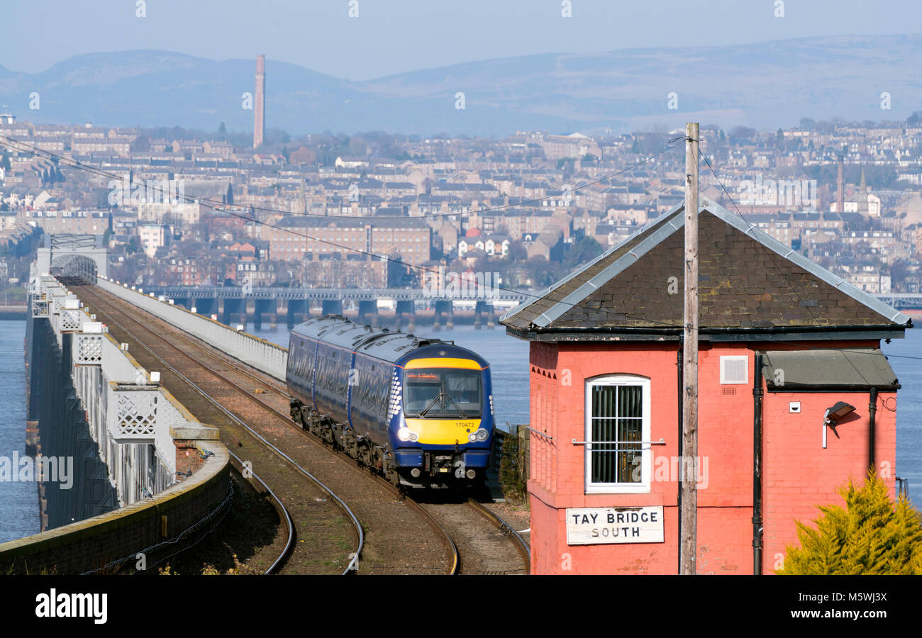 View of Scotrail diesel passenger train travelling from Dundee across the Tay Rail Bridge at Wormit in Tayside, Scotland, United Kingdom Stock Photo