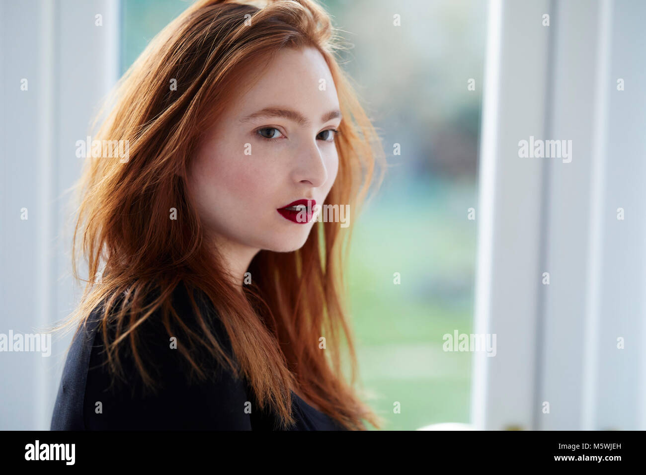 Attractive red haired girl thinking Stock Photo