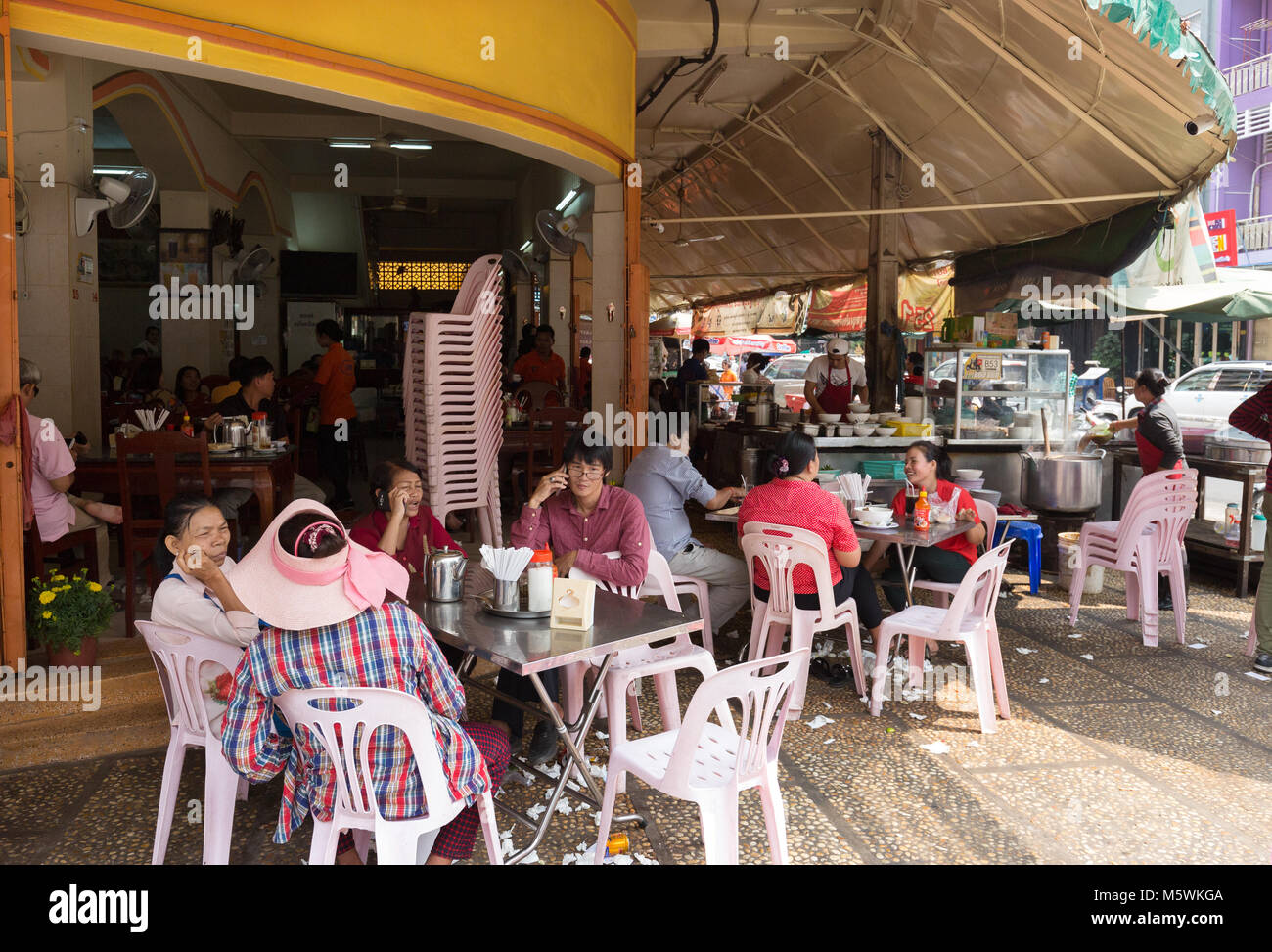 People sitting at a Phnom Penh street cafe bar, Phnom Penh, Cambodia Asia Stock Photo