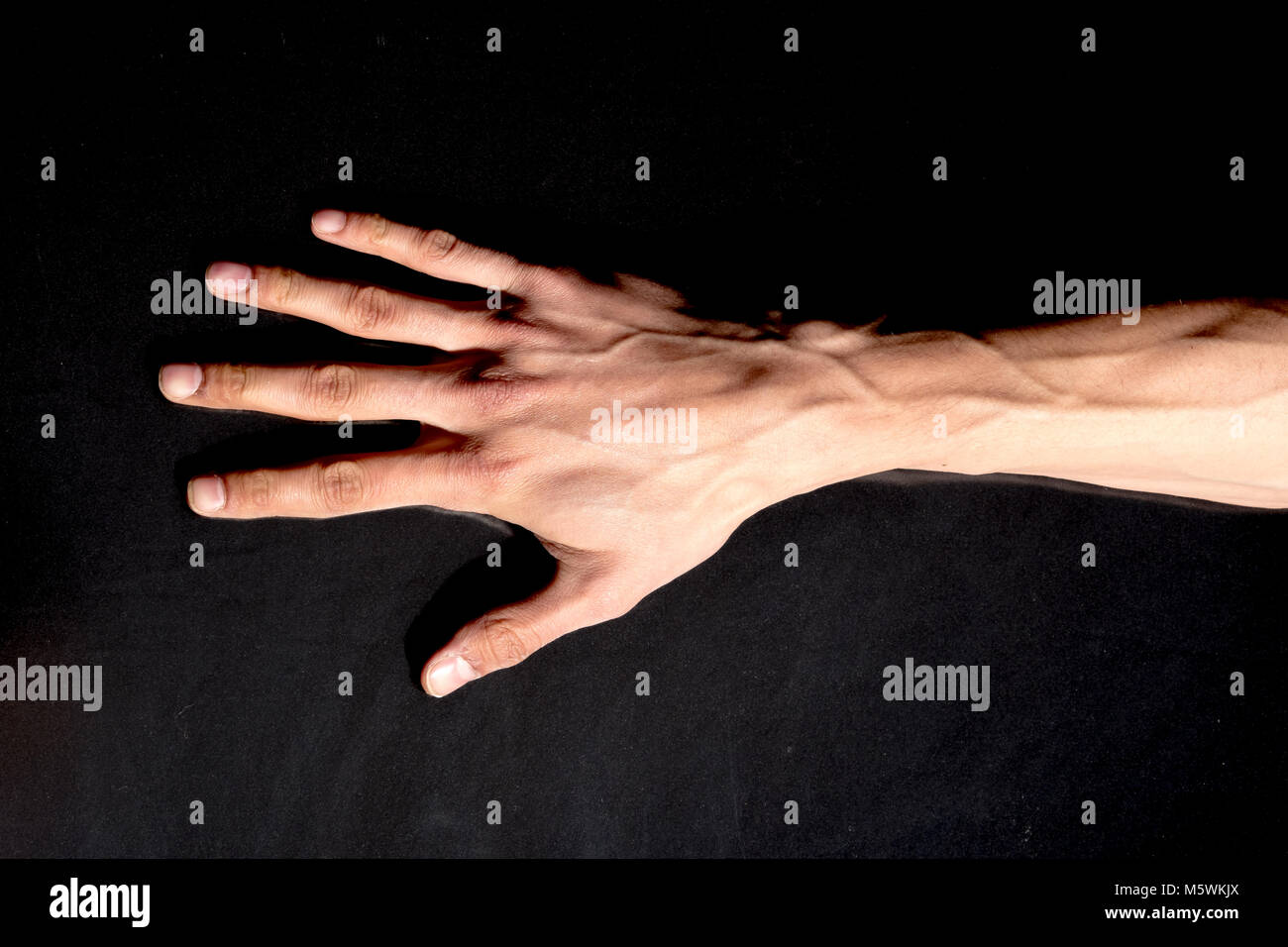 Man hand isolated on black background Stock Photo