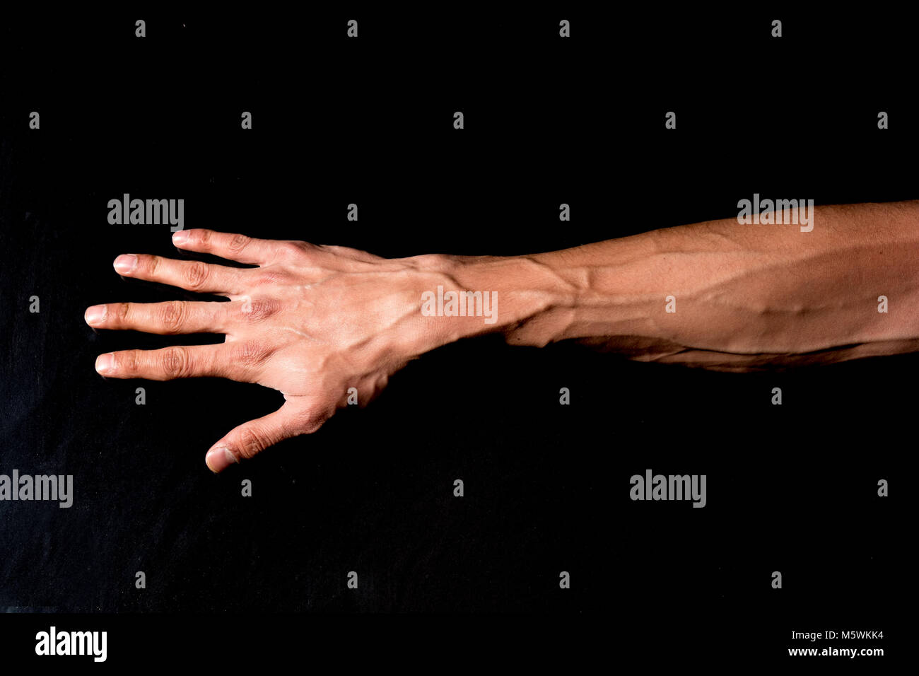 Man hand isolated on black background Stock Photo