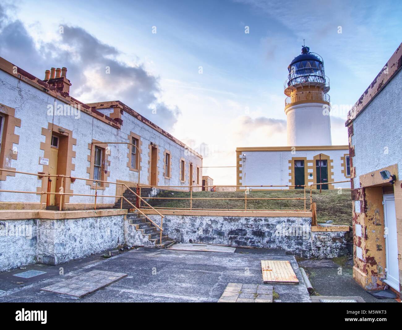 Old lighthouse on Neist Point, abandoned building with tower against to ...