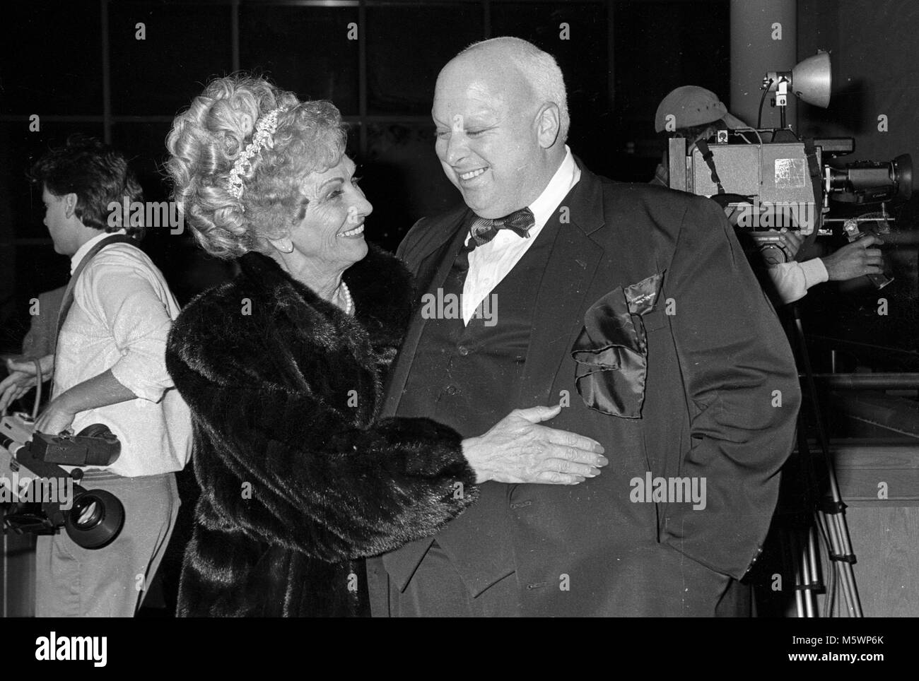 Baltimore, MD 2-16-1988 (file photo) Divine (Harris Glen Milstead) gets a hug from his mother, Diane, 'Frances' Milsteadu at the premiere of the orginial movie, 'Hairspray'.  This was the first time that Divine and his mother had been together in ten years.  Divine died six weeks after the premiere.  Photo by Patsy Lynch/ MediaPunch   All rights reserved Stock Photo