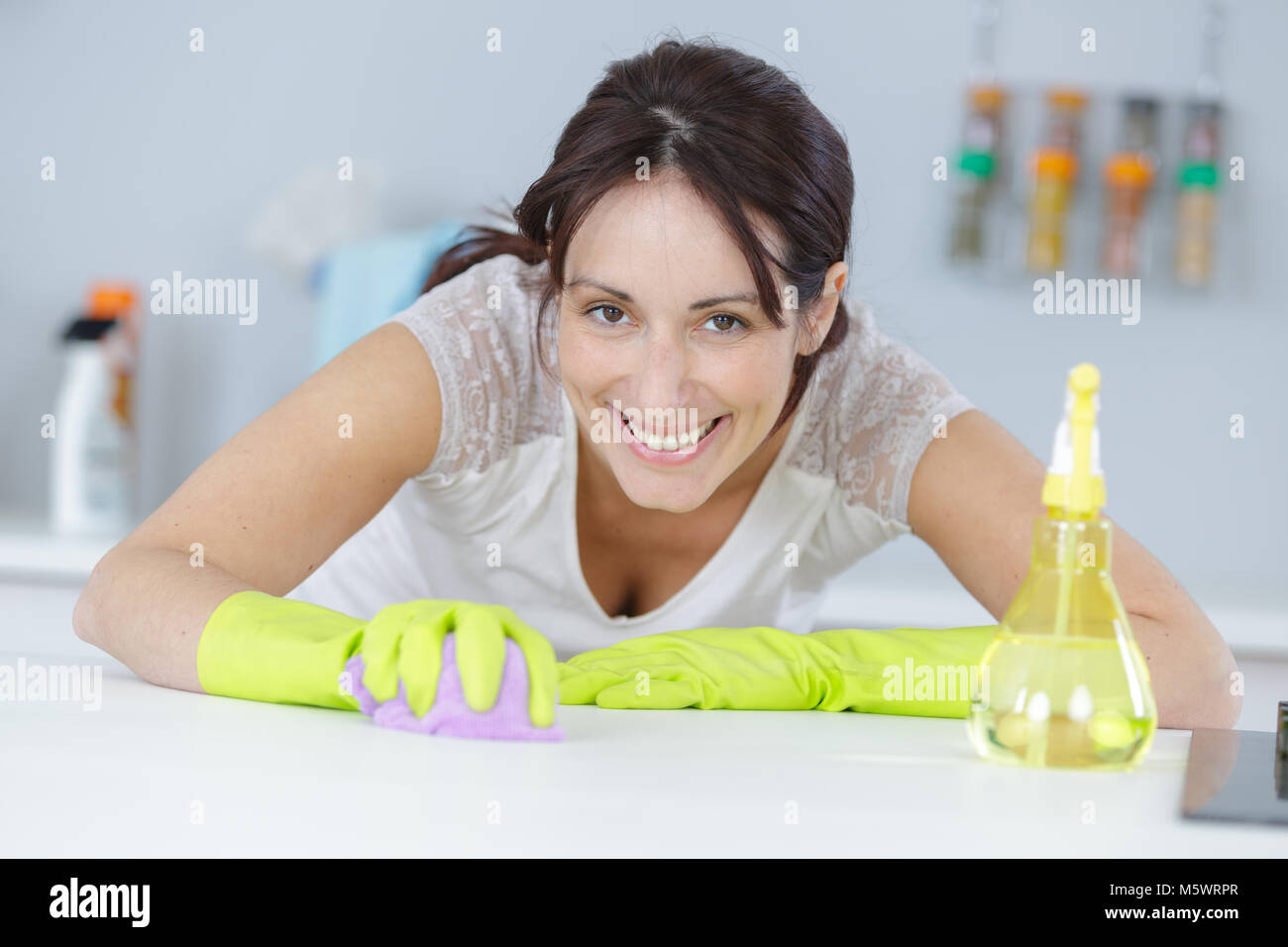 Woman scrubbing work surface Stock Photo Alamy