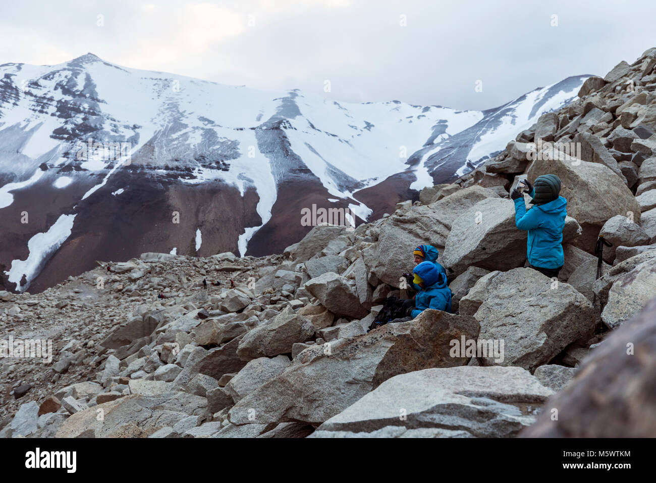 Trekkers at dawn; mirador de las torres; Cordillera Paine; east of Torres del Paine spires; Torres del Paine National Park; Chile Stock Photo
