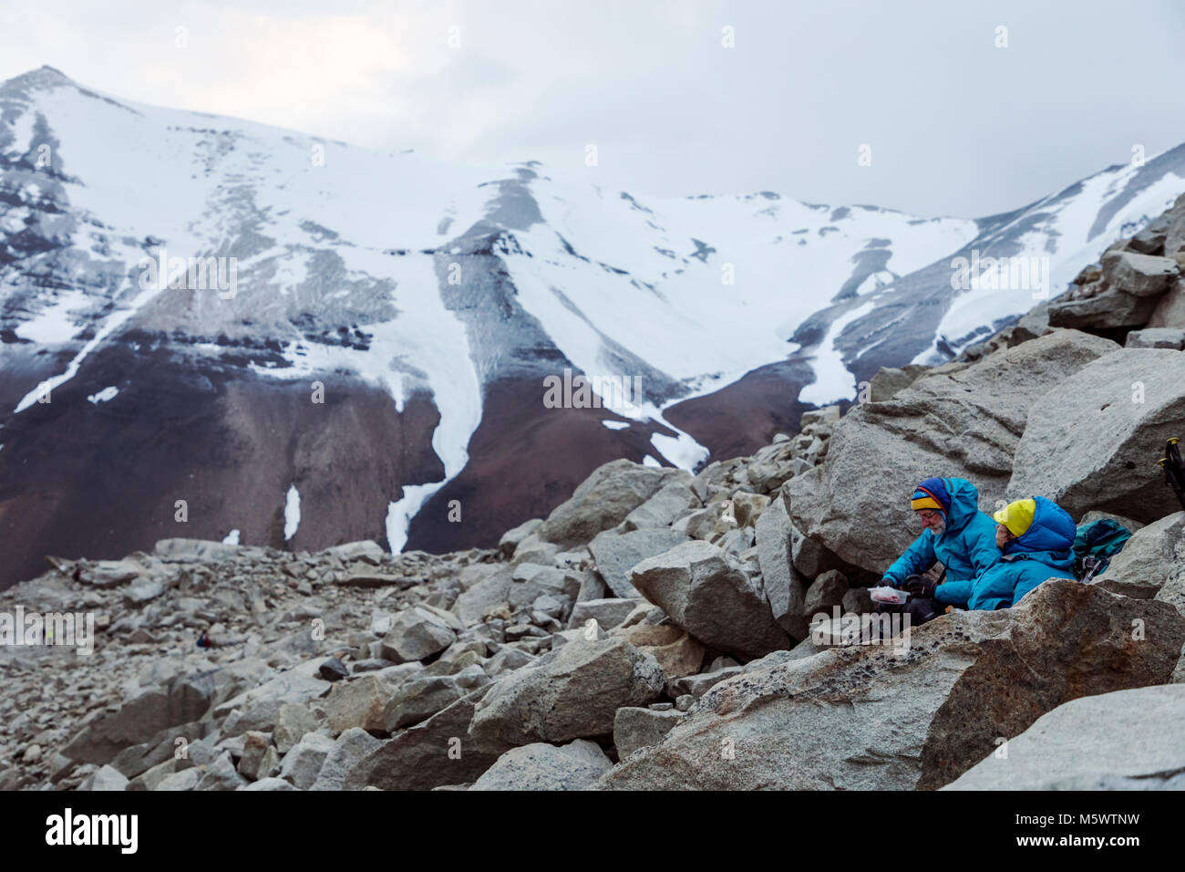 Trekkers at dawn; mirador de las torres; Cordillera Paine; east of Torres del Paine spires; Torres del Paine National Park; Chile Stock Photo