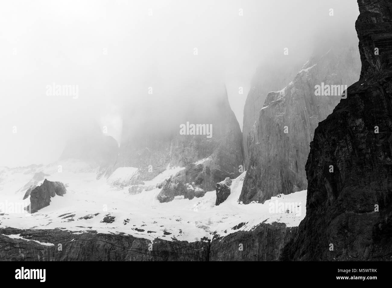 Black & white pre dawn misty view of Torres del Paine; Torre Central; Torre Norte; Monzino; Cordillera del Paine; Torres del Paine Nat'l. Park; Chile Stock Photo