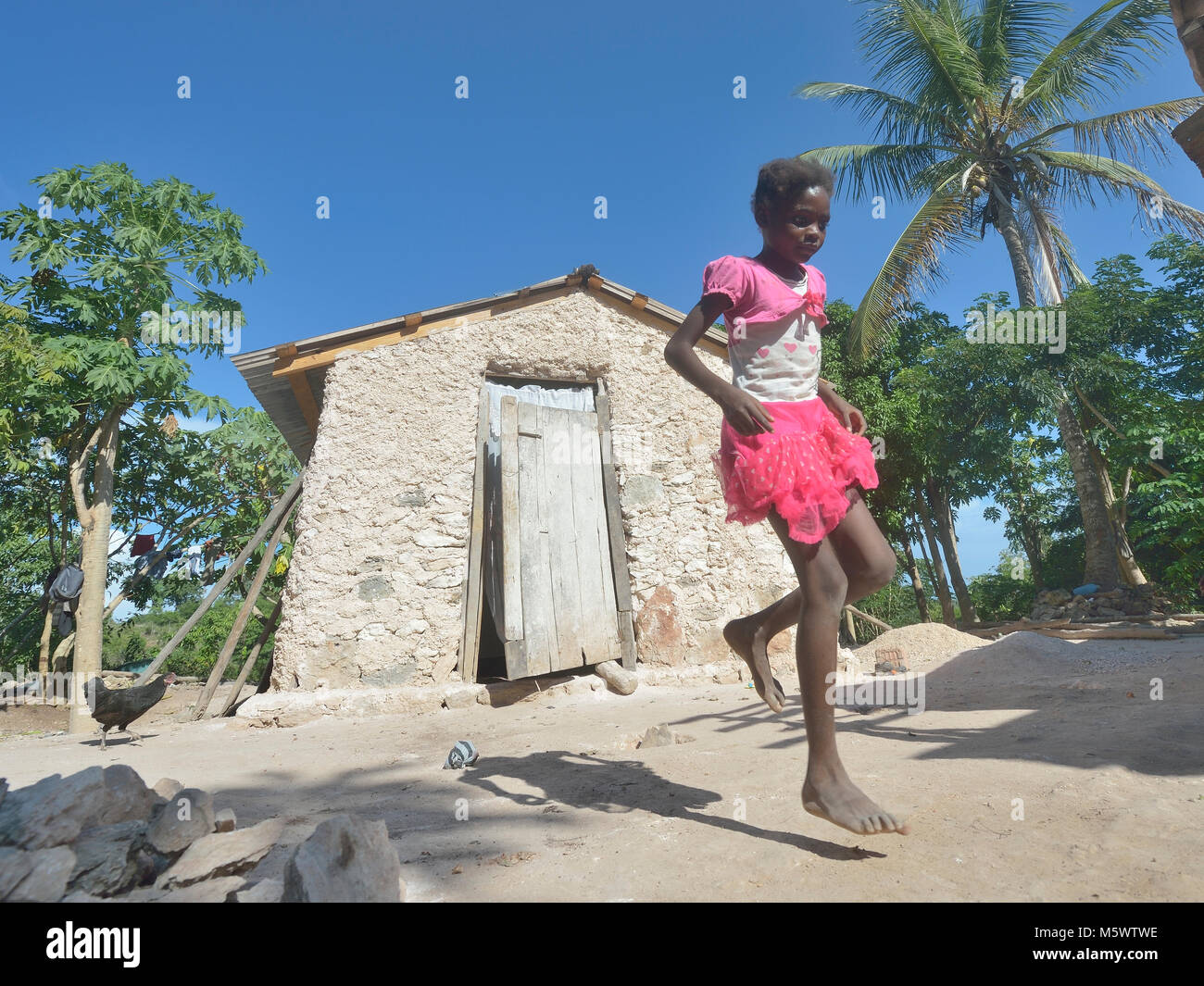 Iznaida Dalmas, 7, plays hopscotch in front of her familiy's new house ...