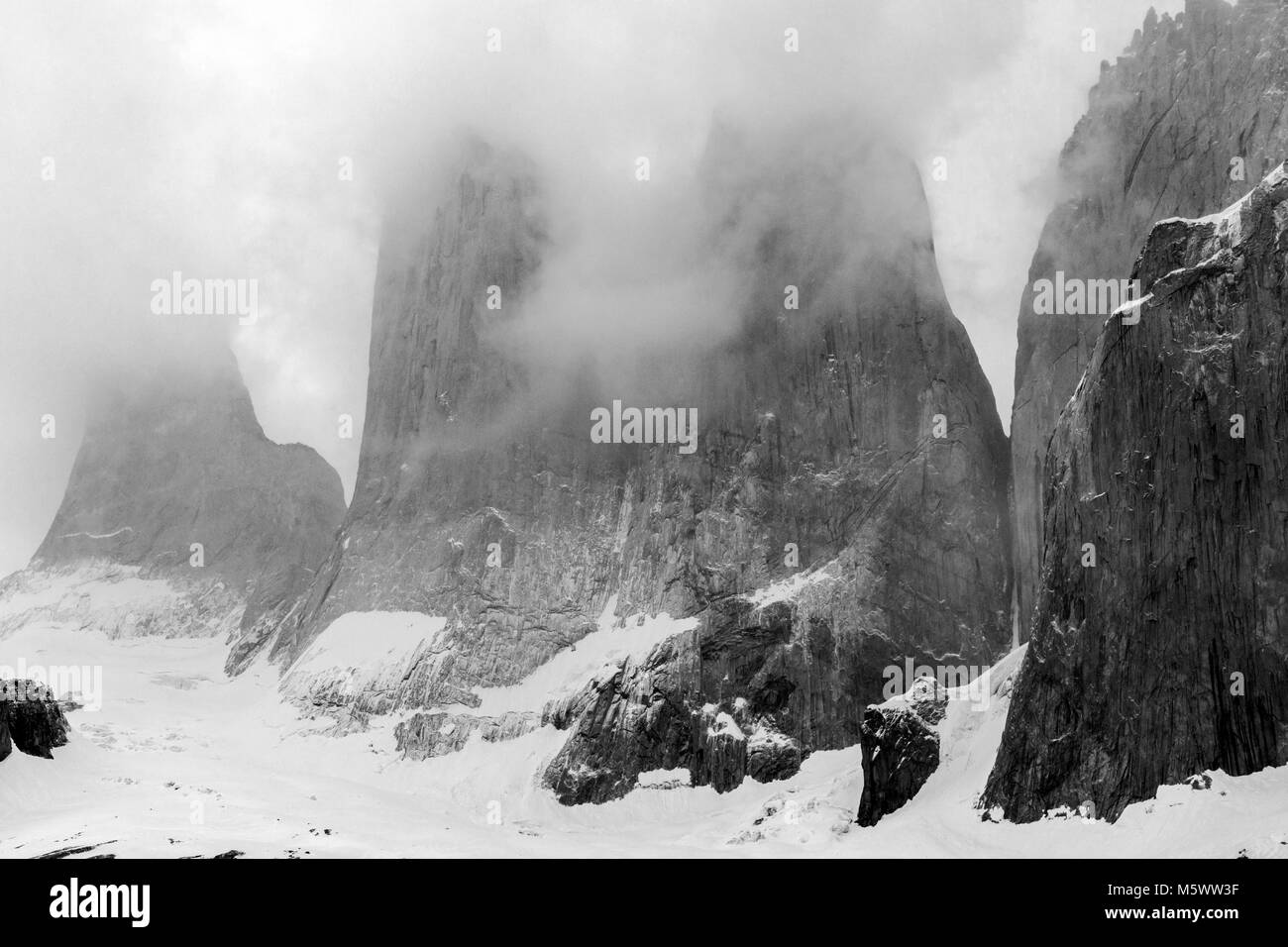 Black & white pre dawn misty view of Torres del Paine; Torre Central; Torre Norte; Monzino; Cordillera del Paine; Torres del Paine Nat'l. Park; Chile Stock Photo