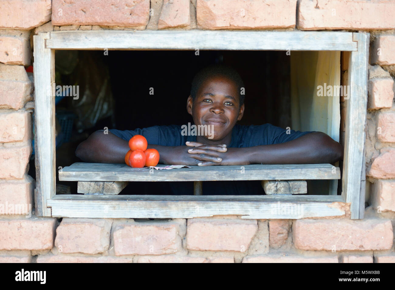 Chris Zulu poses in the small store she installed in her home in Kaluhoro, Malawi. Stock Photo