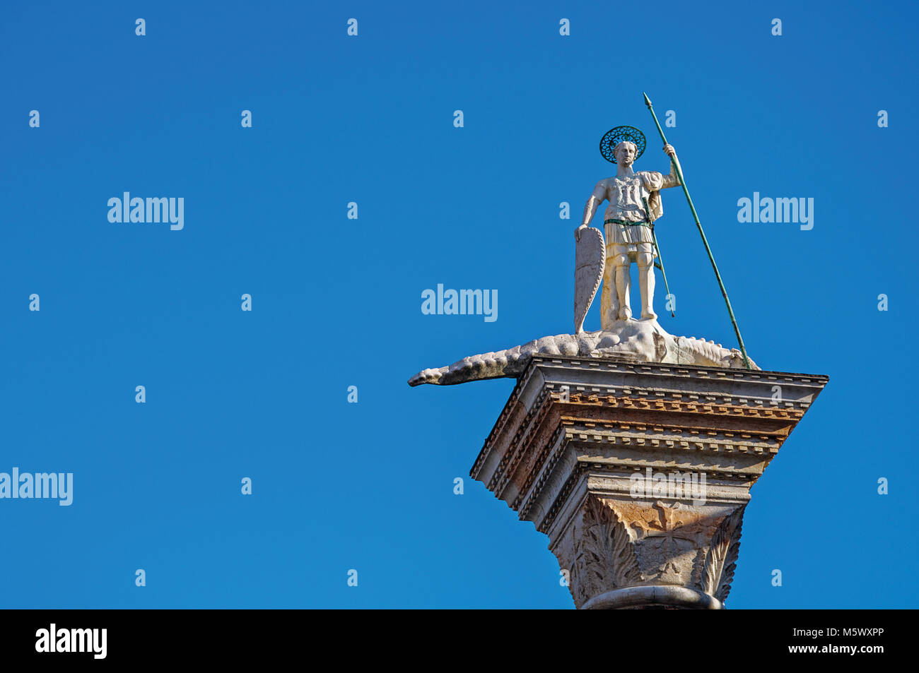 Close-up of St. Theodore's Column in St. Mark's Square with blue sunny ...