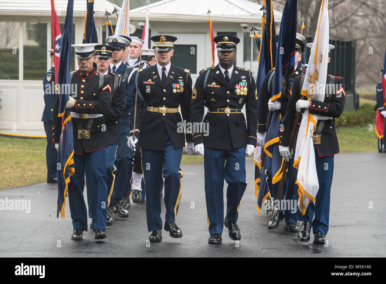 U.S. service members march in formation during an armed forces full honor cordon in honor of Australian Prime Minister at the White House in Washington, D.C., Feb. 23, 2018. (U.S. Army photo by Zane Ecklund) Stock Photo