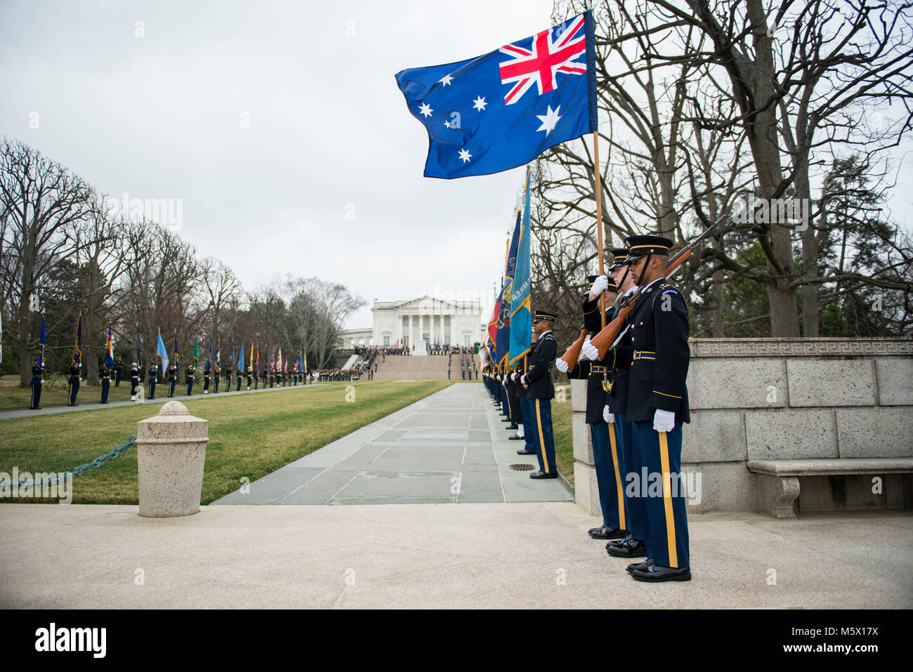 The U.S. Army Color Guard carry the Australian flag during an Armed Forces Full Honors Wreath-Laying at the Tomb of the Unknown Soldier hosted by Australian Prime Minister Malcolm Turnbull at Arlington National Cemetery, Arlington, Virginia, Feb. 22, 2018.    Turnbull met with Arlington National Cemetery senior leadership and toured the Memorial Amphitheater Display Room as part of his official visit to the United States.     (U.S. Army photo by Elizabeth Fraser / Arlington National Cemetery / released) Stock Photo