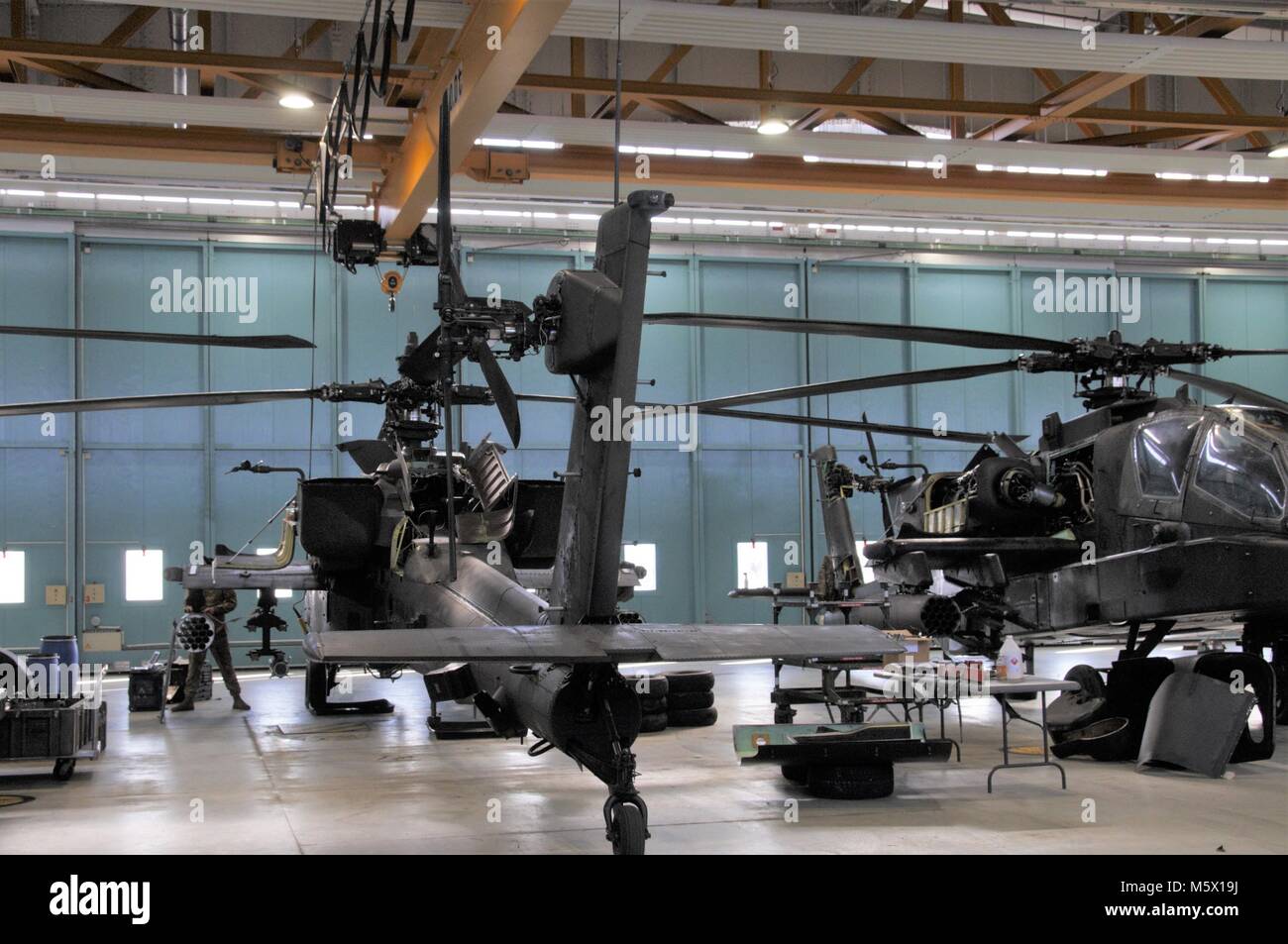 Soldiers of 1st Battalion, 3rd Aviation Regiment (Attack Reconnaissance) conduct 500 hours phase maintenance on an AH-64 Apache helicopter at Katterbach Army Airfield, Germany, Feb. 23, 2018. Phase maintenance inspections occur at regular intervals on all aircraft in order to keep them operational. (U.S. Army photo by Charles Rosemond) Stock Photo