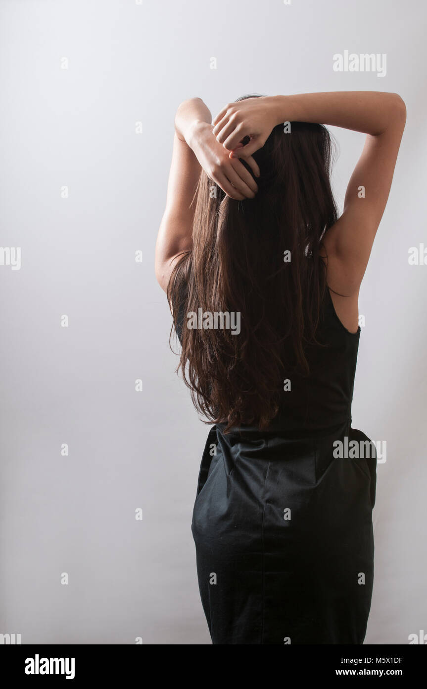 Rear view of a young woman hands on head Stock Photo - Alamy