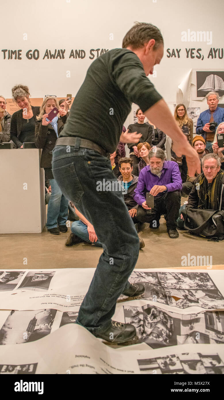 Portland, Oregon, USA. 26 FEB, 2018. A performance artist shreds photographer Robert Frank’s work with ice skates at Blue Sky Gallery in Portland, Oregon, USA. The work was destroyed in a “Destruction Dance” performance defacing the photographs with ink and mutilation with scissors, knives and even ice skates  at the end of it’s run. The destruction was Frank's protest regarding today's greed in the global art market. Credit: Ken Hawkins/Alamy Live News Stock Photo