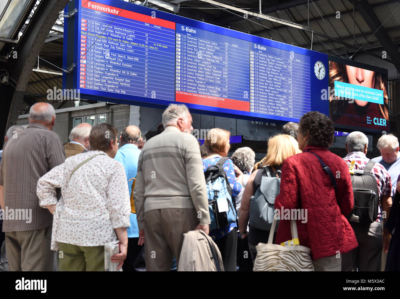 Zurich, Switzerland -  June 03, 2017: People on the Zurich main railway station and electronic board with a train schedule. Zurich central train station (Zurich Hauptbahnhof). Stock Photo
